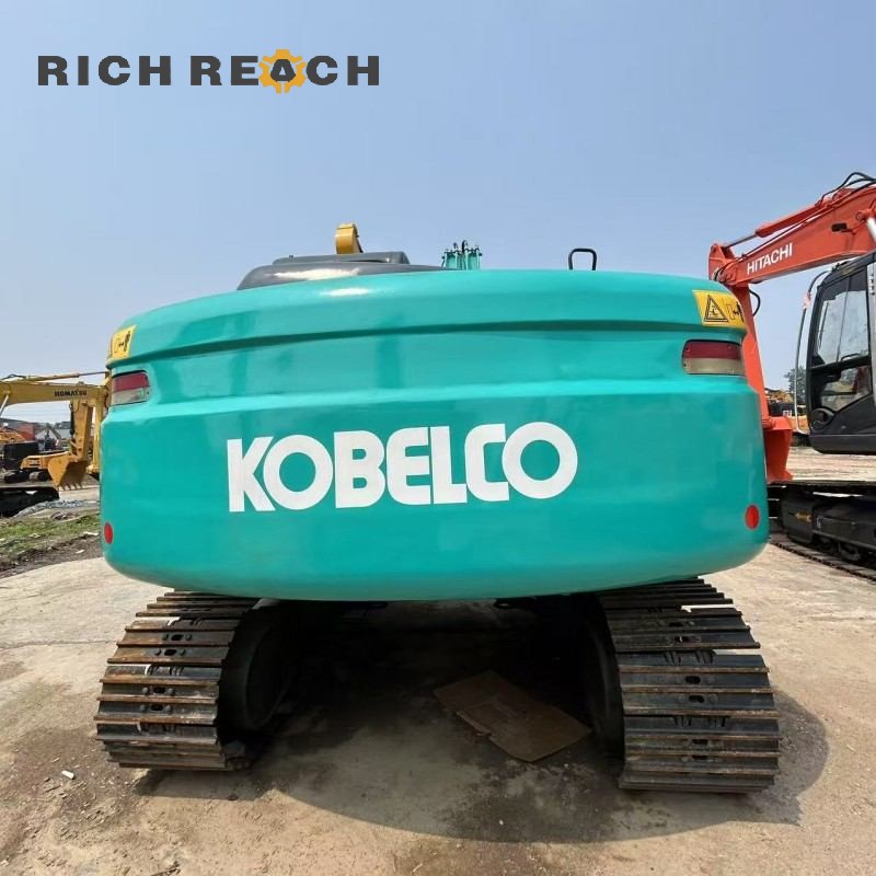 Side profile of a 2017 Kobelco SK130 excavator showing boom and arm, price $20,833